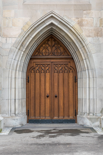 Wooden arched door of church in Zurich, Switzerland