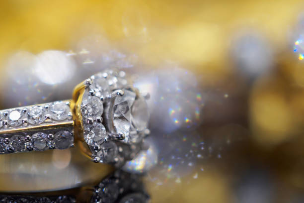 istock Luxury gold Jewelry diamond rings with reflection on black background 969259716