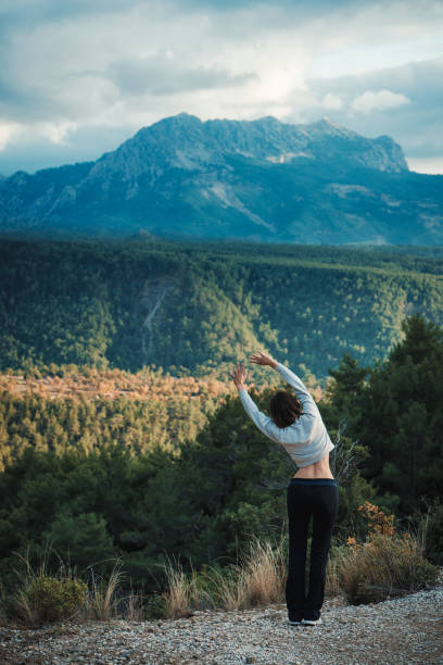 istock Young female runner warming up before running at morning forest trail 969262340