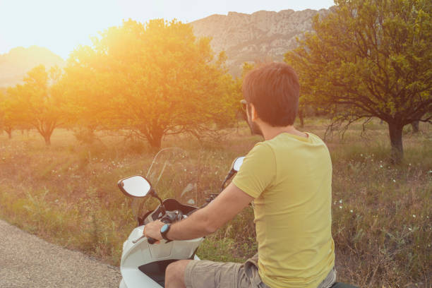 istock man posing on a scooter in a vacation context 969268938