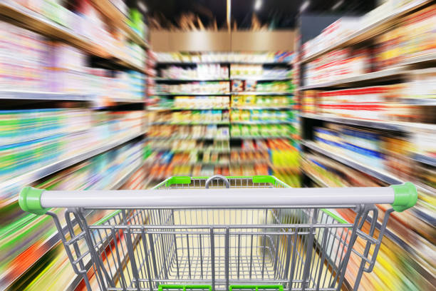 istock Supermarket aisle motion blur with empty shopping cart 969274384