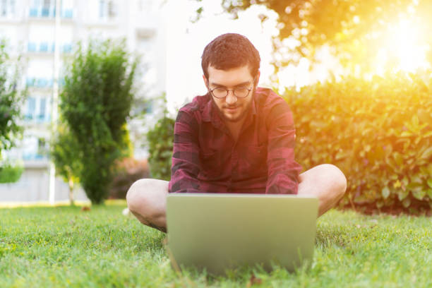 istock Happy hipster with laptop in the forest 969274610