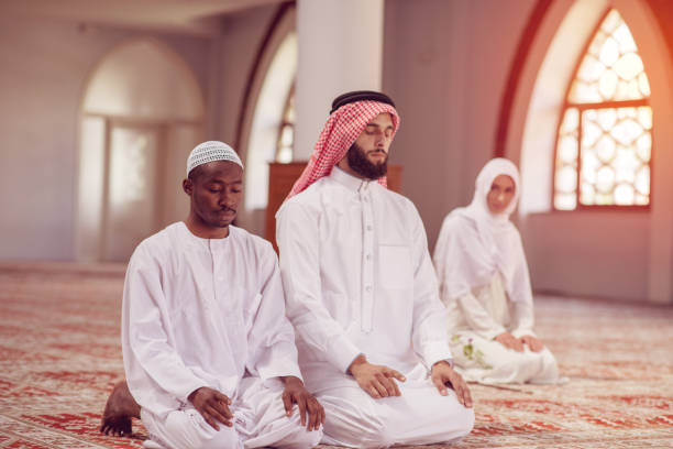 istock Two religious young people praying inside the mosque. islamic 969285338