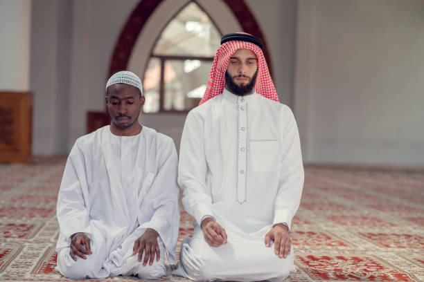 istock Two religious muslim man praying together inside the mosque 969287674