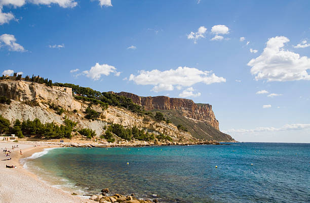 Transparent turquoise water of Aegean Sea with safety buoys sandy beach and clear skies. Rhodes. Greece.