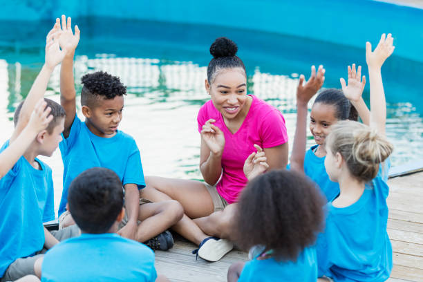 istock Children on field trip at marine park, raising hands 969291042