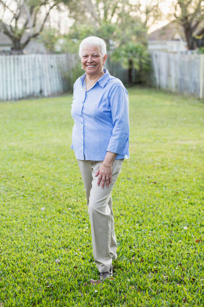 istock Senior Hispanic woman standing in back yard 969294250