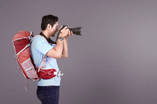 istock Handsome asian photographer man taking a photos with camera 969297900
