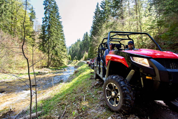 A tour group travels on ATVs and UTVs on the mountains A tour group travels on ATVs and UTVs on the mountains. off road vehicle photos stock pictures, royalty-free photos & images
