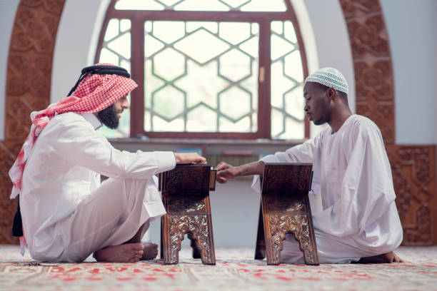 istock Two muslim men reading Koran in the mosque 969298138