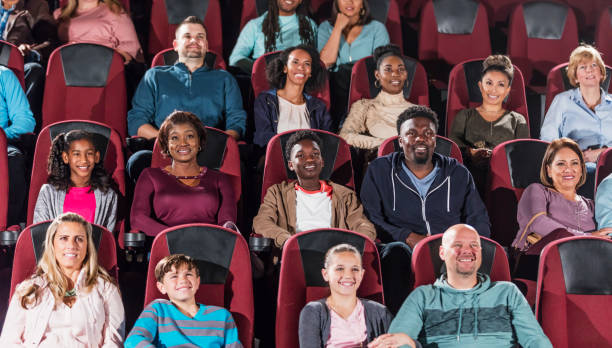 istock Multi-ethnic audience watching movie in theater 969306030