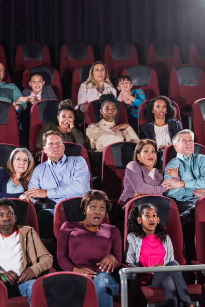 istock Multi-ethnic audience watching scary movie in theater 969307110