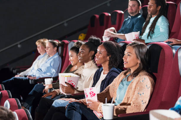 istock Multi-ethnic audience watching movie in theater 969310342
