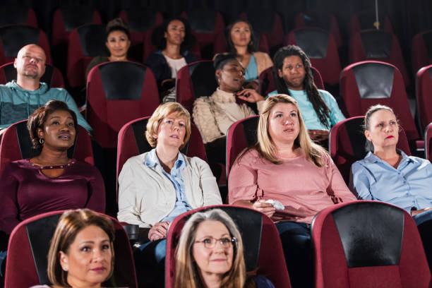 istock Multi-ethnic audience watching movie in theater 969310572