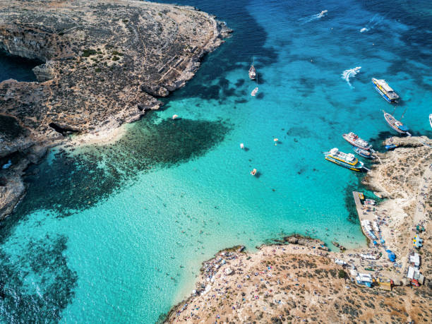 Drone photo - The famous Blue Lagoon.  Camino island, Malta Aerial drone photo - The famous Blue Lagoon in the Mediterranean Sea.  Comino Island, Malta. malta photos stock pictures, royalty-free photos & images