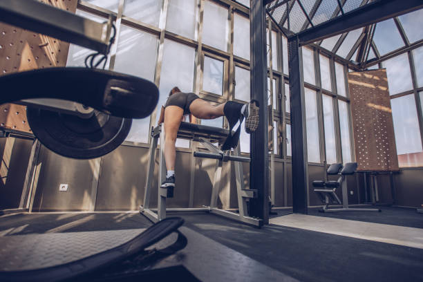 istock Woman exercises in gym 969328194