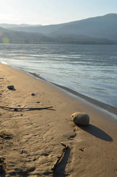 A stone has created a path on the beach.