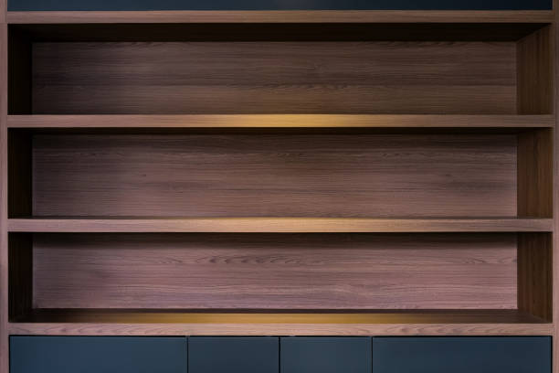 empty space of built in wooden shelf at wall with down-light