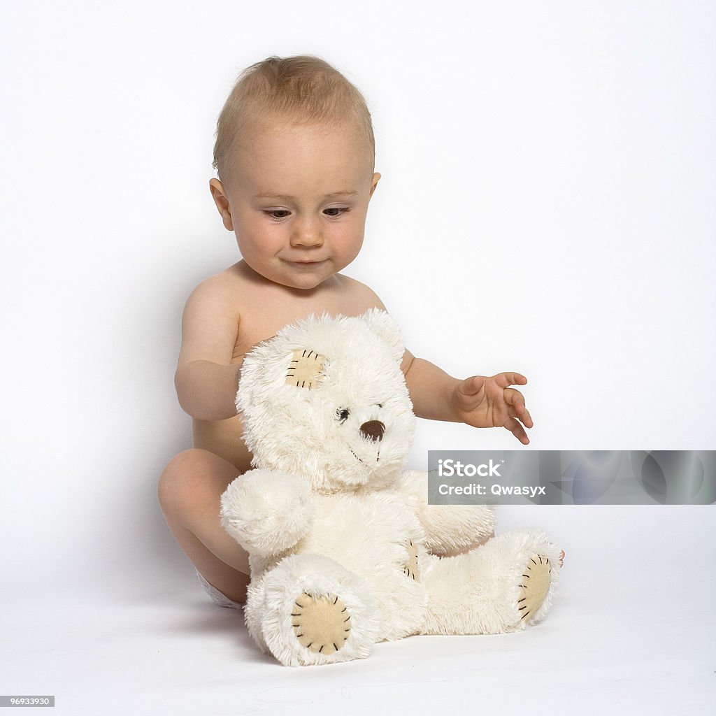 CUTE INFANT WITH TEDDY BEAR  Alertness Stock Photo