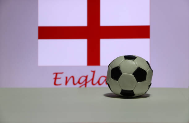 Small football on the white floor and English nation flag with the text of England background. The concept of sport. stock photo