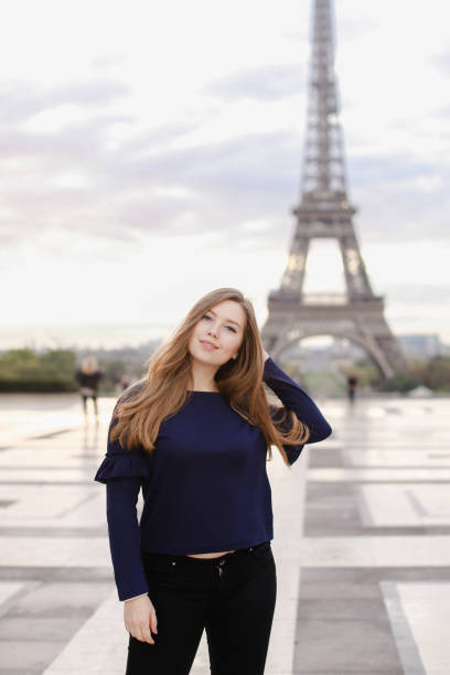 istock Beautiful woman standing in Eiffel Tower background in Paris 969348178