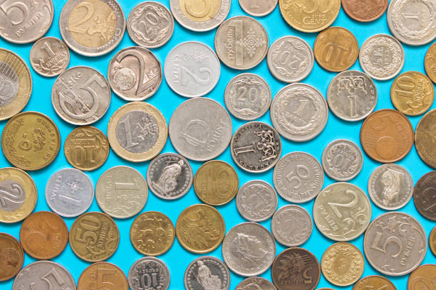 istock Many different coins on blue background . The concept of saving 969352578