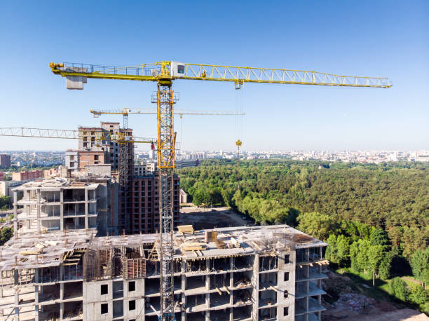 istock new apartments building under construction against blue sky 969352892