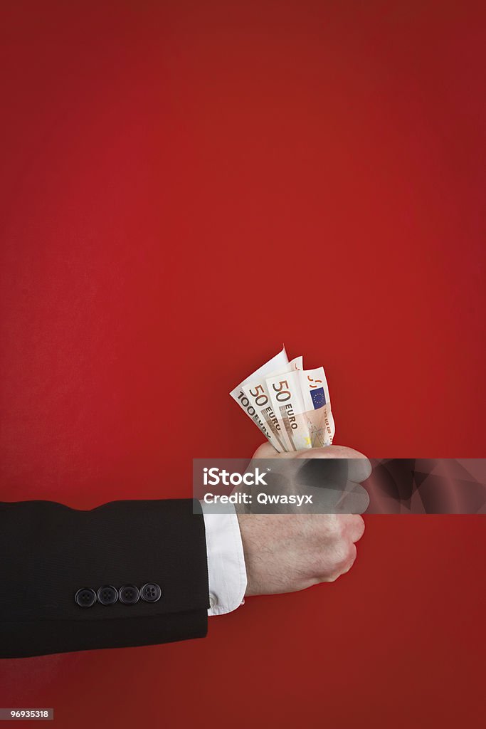 Fist of money  Gripping Stock Photo