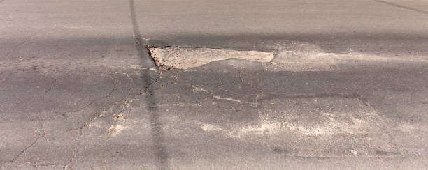 istock bad asphalt road, pit on the road 969360654