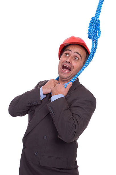 Business man hanging on a rope stock photo