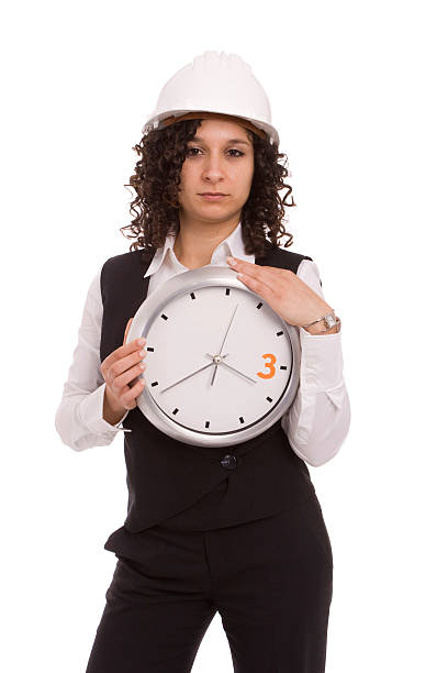 Young engineer holding a clock stock photo