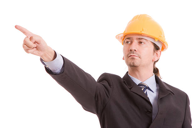 Engineer with yellow hat, pointing forward stock photo