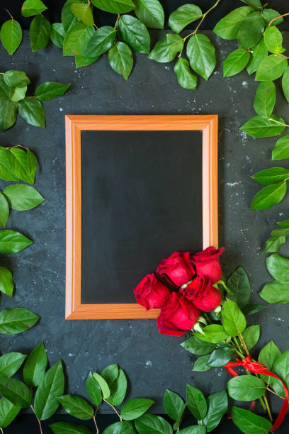 istock Red roses with green foliage leaves romantic valentine mock up frame for texts 969391324