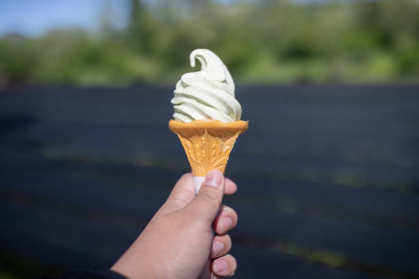 istock Hand holding Wasabi ice cream cone on Wasabi farm background. 969396844