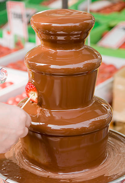 Strawberry in a chocolate fountain stock photo