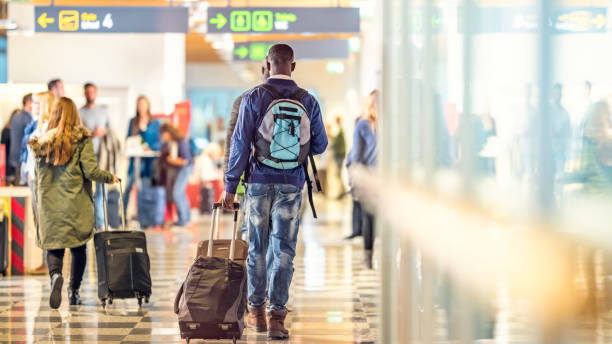 istock Man walking to the airport gate with his suitcase 969399120