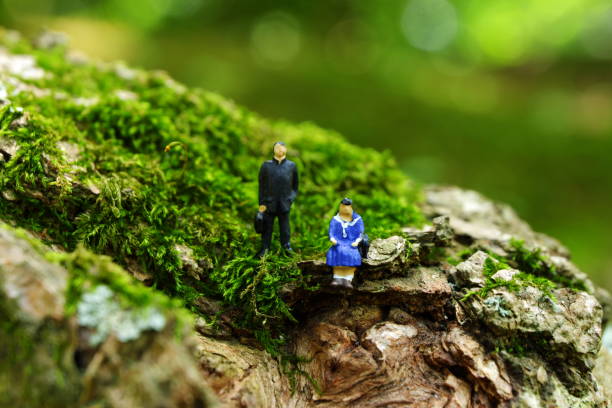 istock High school student couple doll sitting in nature 969399872