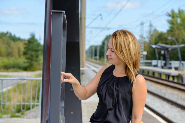 istock Woman looking a timetable in a station 969403030