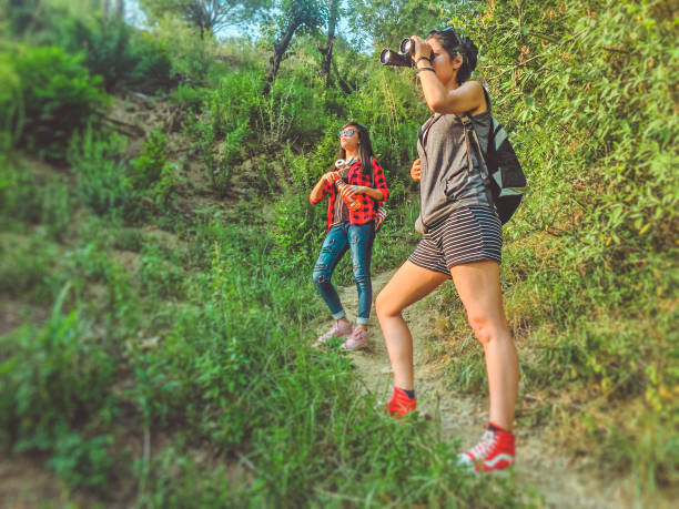 istock Young women using binoculars while hiking in mountain woods. 969403222