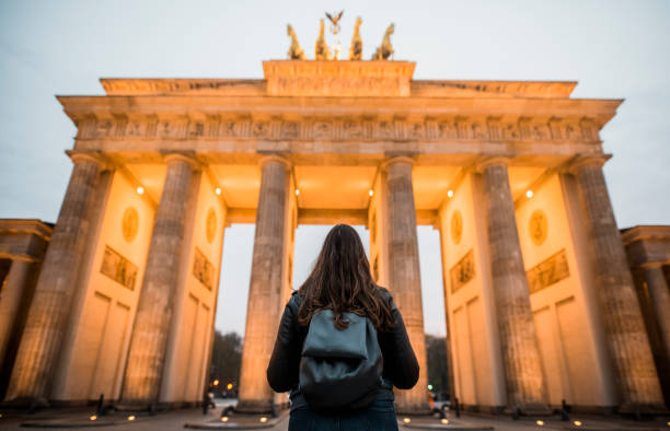 istock Woman with backpack looking at Bradenburg Gate 969411618