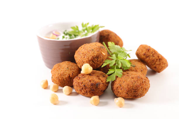 Chickpea falafel with fresh herbs on a white table, horizontal, copy space