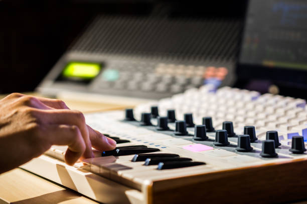 istock musician hands playing midi keyboard in sound studio, recording concept 969415334