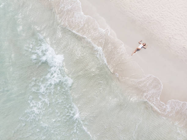 istock Woman Lying On a Beach 969418486