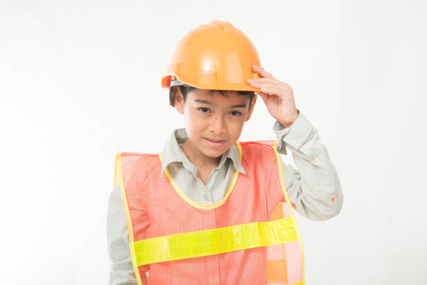 istock Little engineer boy with protecion hat on his head 969422330
