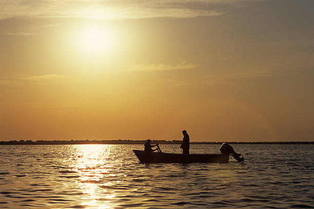 istock people fishing in sunrise 96942248