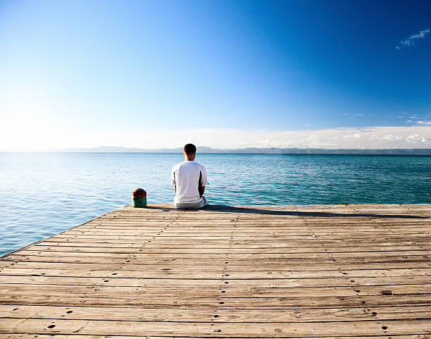 istock young man relax watch on ocean 96943135