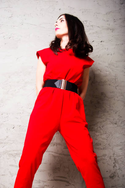 istock Beautiful young brunette is standing, leaning against the wall. 969431460