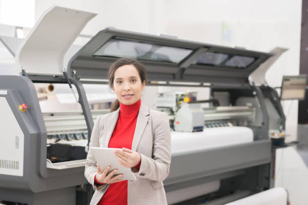 istock Smiling confident mixed race manager of printing company checking data on tablet while preparing files for print in modern company 969432012