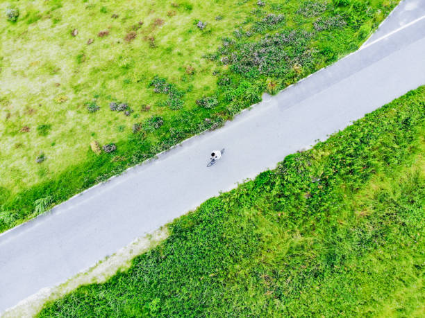 Couple riding their bicycle at a dirt road in Overijssel, Netherlands
