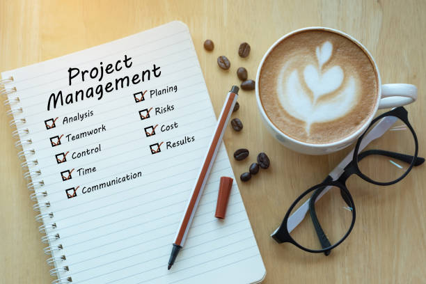 Project management and check list marks in notebook with glasses, pencil and coffee cup on wooden table. Project management concept. Project management and check list marks in notebook with glasses, pencil and coffee cup on wooden table. Project management concept. project management photos stock pictures, royalty-free photos & images